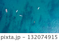 People practicing paddleboarding on the sea 132074915