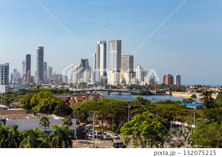 Panoramic view of the modern skyline of Cartagena de Indias, Colombia, featuring high-rise buildings against a clear blue sky. 132075215