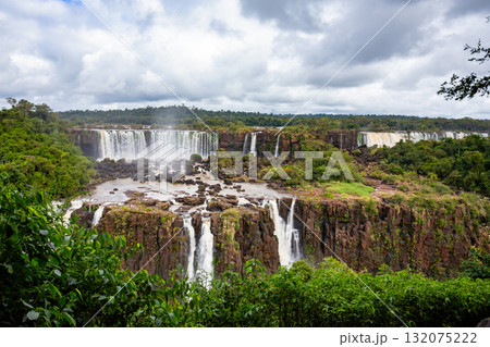 Powerful Iguazu Falls, one of the world most impressive waterfalls. Brazil side. Brazilian wilderness landscape. Powerful Iguazu Falls, one of the world most impressive waterfalls. Brazil side. Brazilian wilderness landscape. 132075222