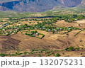 Scattered Ethiopian huts and farm plots in the highlands of the Southern Nations, Ethiopia. 132075231