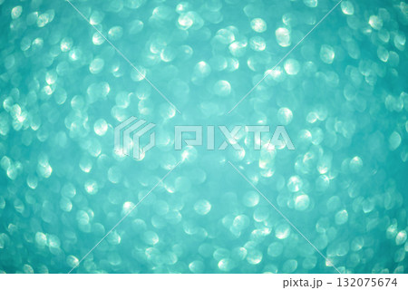 Defocused lights from turquoise glitter as a background. Defocused lights from turquoise glitter as a background. 132075674