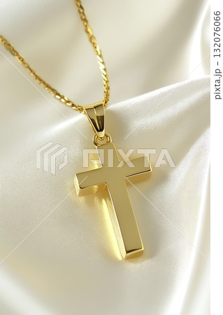 Gold cross pendant is displayed on a white background Gold cross pendant is displayed on a white background 132076066