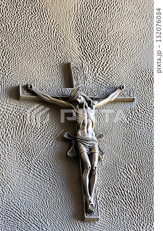 Silver cross with a man in the center of it 132076084