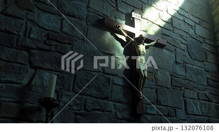 Crucifix is hanging on a wall in a dark room 132076108