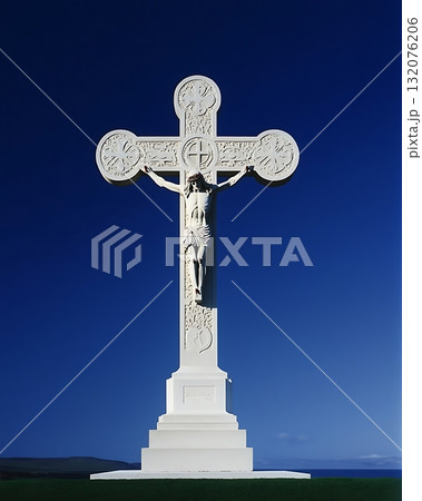 White cross with a statue of Jesus Christ on top of it 132076206