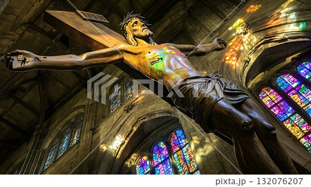 Wooden cross with a man on top of it Wooden cross with a man on top of it 132076207