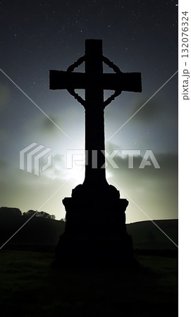 Large cross is silhouetted against the night sky 132076324