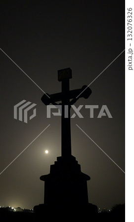Large cross is standing in the dark with a full moon in the background 132076326
