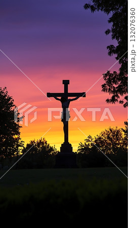 Cross is silhouetted against a beautiful sunset 132076360