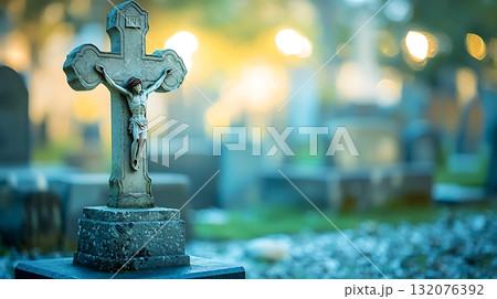 Cross with Jesus Christ on it is in front of a cemetery 132076392