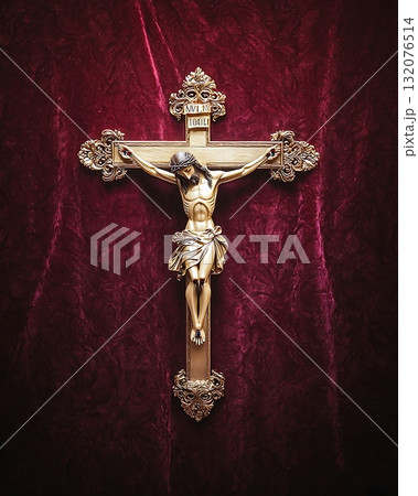 Gold cross with a man holding it in the middle 132076514