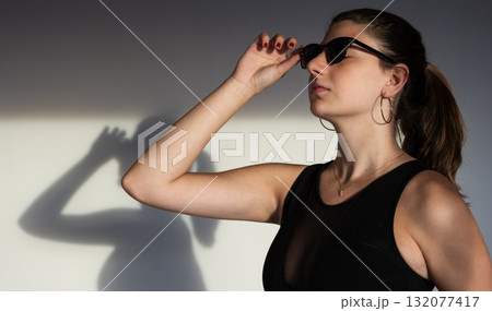 Modern portrait in warm light with soft shadows, ideal for branding, editorial, and social media use 132077417