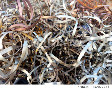 Metal Steel Shavings Collected After Turning Process in a Workshop Setting 132077741