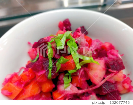 Colorful Salad With Leek, Potato, and Beet Served in a Bowl on a Countertop 132077746