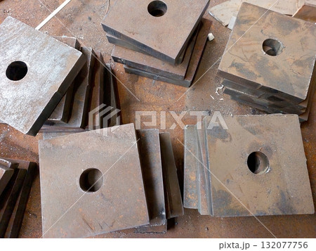 Square Metal Parts Arranged for Fastening in a Workshop Setting During Daylight Hours Square Metal Parts Arranged for Fastening in a Workshop Setting During Daylight Hours 132077756