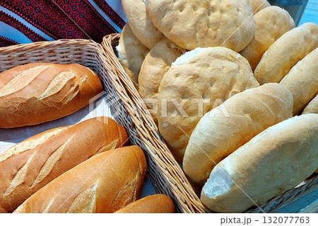 Freshly Baked Wheat Bread Displayed in a Rustic Basket at a Local Market During Midday Freshly Baked Wheat Bread Displayed in a Rustic Basket at a Local Market During Midday 132077763