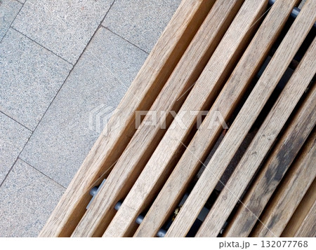 Wooden Strips Arranged Neatly on a Bench in a Public Space During Daylight Hours 132077768