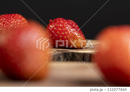 ripe sweet and juicy strawberries on a wooden table, close up 132077884