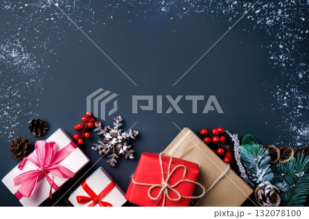 Colorful holiday gifts and decorations arranged on a dark background ready for a festive celebration Colorful holiday gifts and decorations arranged on a dark background ready for a festive celebration 132078100