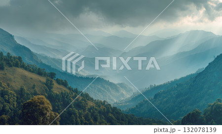 Selling Title: Dramatic Layers of Rolling Hills and Misty Mountains Under a Cloudy Sky: Sun Rays Breaking Through and Illuminating the Lush, Hazy Valleys of a Grand Landscape Selling Title: Dramatic Layers of Rolling Hills and Misty Mountains Under a Cloudy Sky: Sun Rays Breaking Through and Illuminating the Lush, Hazy Valleys of a Grand Landscape 132078139