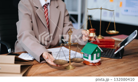 Real Estate Lawyer And House Foreclosure Law. House model, hammer judge gavel on table with white background. Real Estate Lawyer And House Foreclosure Law. House model, hammer judge gavel on table with white background. 132080410