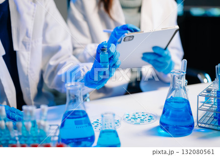 Scientist team meeting and writing analysis results in the laboratory study and analyze scientific Scientist team meeting and writing analysis results in the laboratory study and analyze scientific 132080561