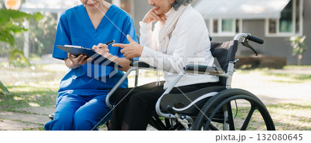 Asian young caregiver nurse support senior older male walking outdoors. Specialis doctor help and take care of elderly mature. 132080645