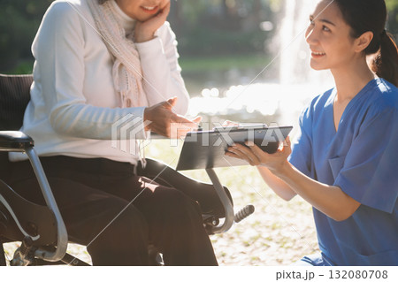 Elderly asian senior woman on wheelchair with Asian careful caregiver. Nursing home hospital 132080708