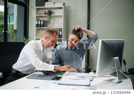 Two business workers talking on the smartphone and using laptop Two business workers talking on the smartphone and using laptop 132080946