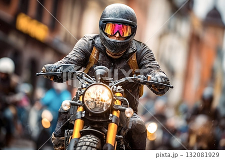 Motorcyclist riding custom scrambler motorcycle in city traffic Motorcyclist riding custom scrambler motorcycle in city traffic 132081929