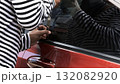 Close up of a thief breaking into a car using a metal tool, symbolizing crime, car theft, security risk, and the importance of vehicle protection, police awareness, and personal safety concept 132082920