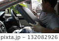 Masked thief reaching into a car window trying to steal a briefcase from a frightened driver. Concept of car robbery, theft, danger, urban crime, and personal security awareness 132082926