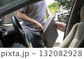 thief and a driver struggling over a briefcase during a car robbery in daylight, showing danger, crime, and violence. Concept of car theft, street crime, personal safety, and self-protection awareness 132082928