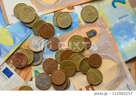 Currency collection spread across banknotes and coins on a flat surface in a cozy indoor setting Currency collection spread across banknotes and coins on a flat surface in a cozy indoor setting 132083257
