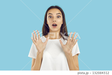 Young woman looking at the camera with a surprised, shocked, happy face expression 132084312