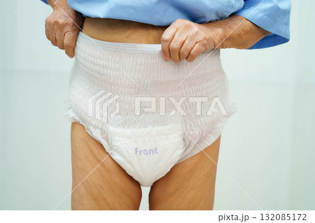 Asian senior woman patient wearing adult incontinence diaper pad in hospital. 132085172