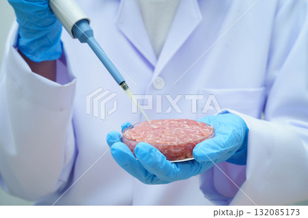 Scientist holding Petri dish with meat in science laboratory for food product development. 132085173