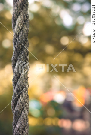 Close-up of a rough rope with soft bokeh background symbolizing strength and connection Close-up of a rough rope with soft bokeh background symbolizing strength and connection 132085211