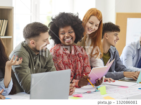 Diverse employees gathered in boardroom for training with African American businesswoman Diverse employees gathered in boardroom for training with African American businesswoman 132086081
