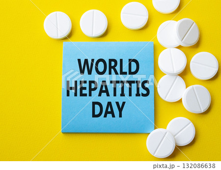 World Hepatitis Day symbol. Concept words World Hepatitis Day on blue note. Beautiful yellow background with pills. Healthcare and World Hepatitis Day concept. Copy space. 132086638