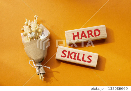 Hard skills symbol. Wooden blocks with words Hard skills. Beautiful orange background with bouquet of flowers. Business and Hard skills concept. Copy space. Hard skills symbol. Wooden blocks with words Hard skills. Beautiful orange background with bouquet of flowers. Business and Hard skills concept. Copy space. 132086669