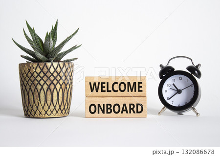 Welcome onboard symbol. Concept words Welcome onboard on wooden blocks. Beautiful white background with alarm clock and succulent plant. Business and Welcome onboard concept. Copy space. Welcome onboard symbol. Concept words Welcome onboard on wooden blocks. Beautiful white background with alarm clock and succulent plant. Business and Welcome onboard concept. Copy space. 132086678