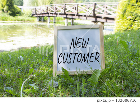 New Customer symbol. Concept word New Customer on white chalk blackboard. Beautiful meadow background with bridge. Business and New Customer concept. Copy space. New Customer symbol. Concept word New Customer on white chalk blackboard. Beautiful meadow background with bridge. Business and New Customer concept. Copy space. 132086710