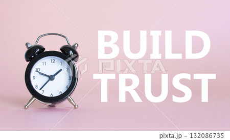 Build trust symbol. Beautiful pink background with alarm clock. Business and Build trust concept. Copy space. Build trust symbol. Beautiful pink background with alarm clock. Business and Build trust concept. Copy space. 132086735