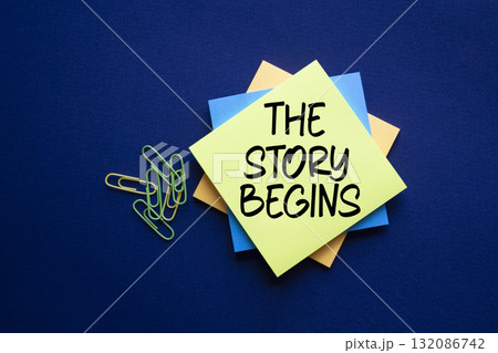 The Story Begins symbol. Sticky notes with words The Story Begins. Beautiful deep blue background. Business and The Story Begins concept. Copy space. 132086742
