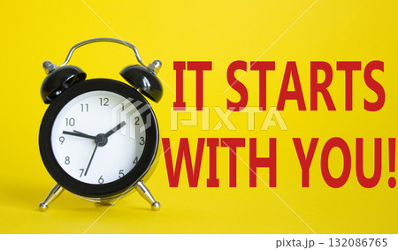 It starts with you symbol. Beautiful yellow background with alarm clock. Business and It starts with you concept. Copy space. 132086765