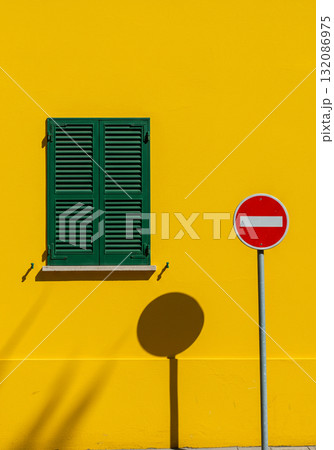 Yellow Wall with Green Shutters and No Entry Sign 132086975