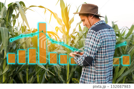 a farmer man analyzing a digital chart or graph on a tablet, focusing on growth and future yields for 2026. farmer reviewing growth chart green field agriculture a farmer man analyzing a digital chart or graph on a tablet, focusing on growth and future yields for 2026. farmer reviewing growth chart green field agriculture 132087983