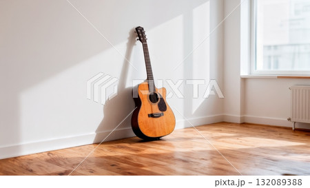 Acoustic Guitar Leaning Against White Wall in Minimalist Interior for Lifestyle Photography 132089388