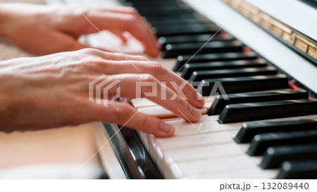 Hands Playing Piano Keys Close-up with Motion Blur for Music Learning and Education Content 132089440